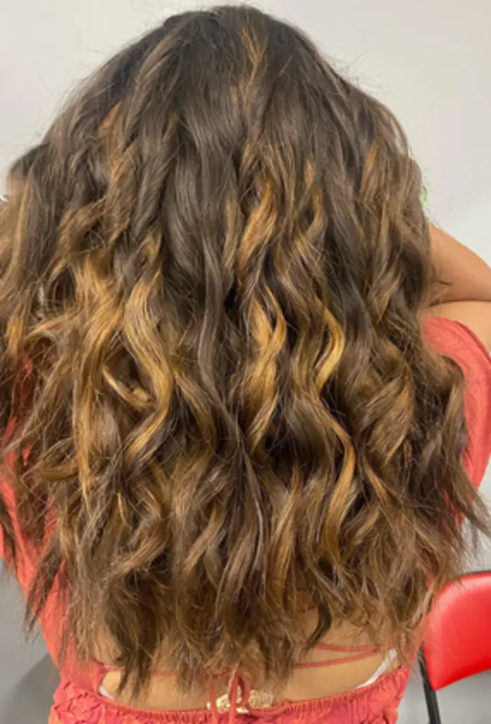 Long wavy hair with warm dimensional highlights